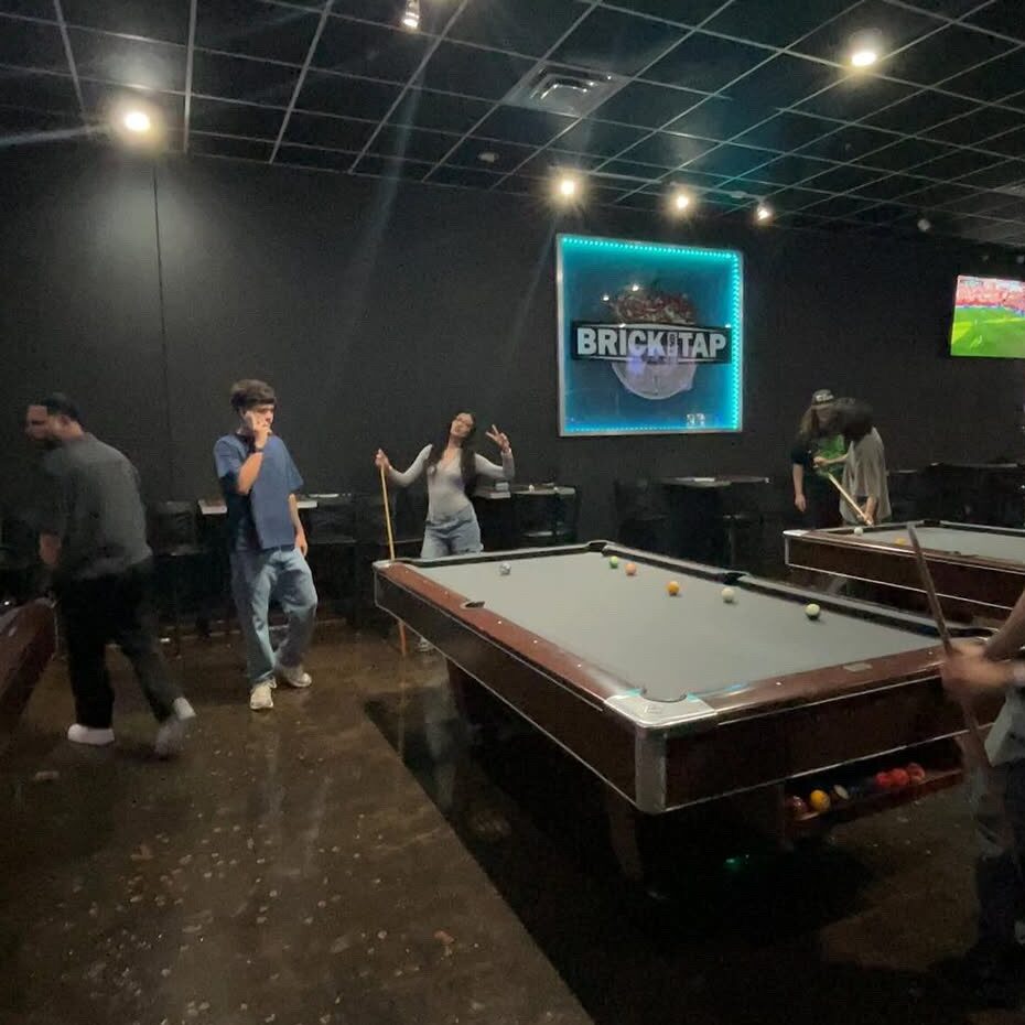 Heritage Ventures Inc. team members playing pool together at a team culture night